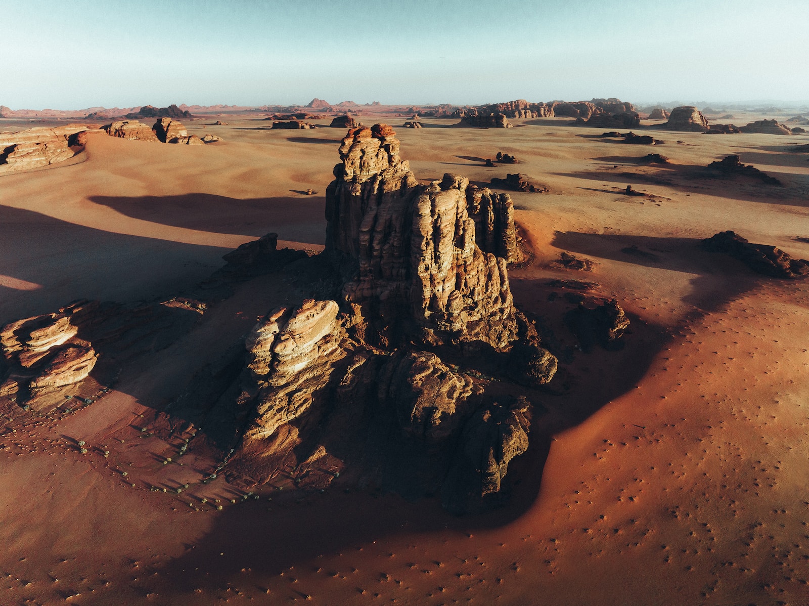 Top places to visit in the world, an aerial view of a desert with rocks and sand